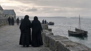 Two women in black shawls on an Irish quay — the dignity of sorrow